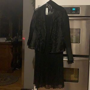 Women’s blazer and skirt combination with scarf.